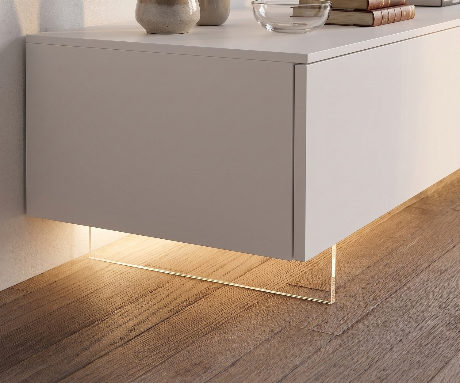 Livitalia Transparent TV Lowboard Plinth Transparent TV lowboard plinth by Livitalia creating a floating effect with LED light on wooden floor.