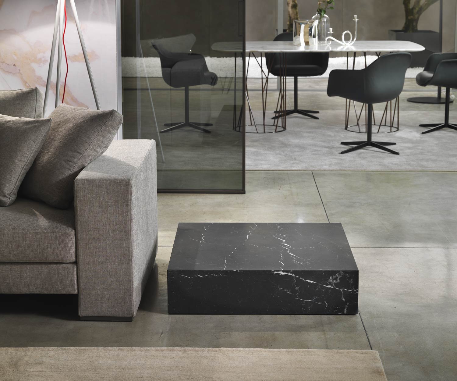 Black Thor coffee table from Marelli on the floor without plinth next to couch Black Thor coffee table from Marelli on the floor without plinth next to couch
