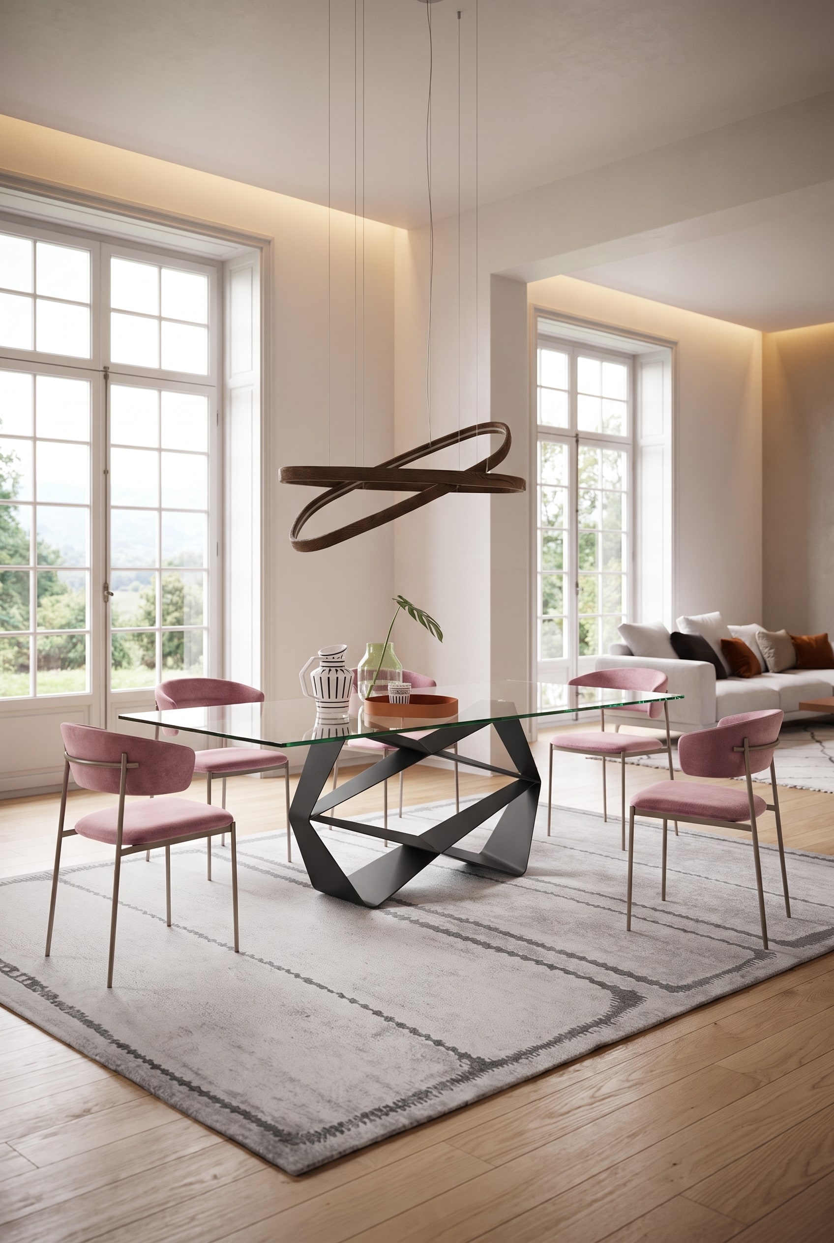 Sala da pranzo luminosa con un tavolo rettangolare in vetro su base a croce nera e quattro sedie imbottite rosa