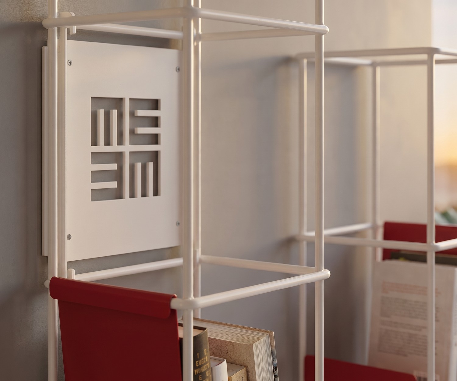 MEME Design Libro Vertical Wall Bookshelf Metal MEME Design Libro vertical wall bookshelf in metal mounted in a modern living room next to an armchair.