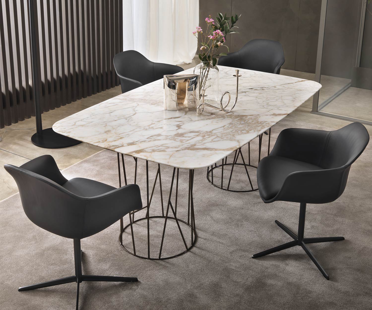 Design dining table Table top in Calacatta marble arranged as a group with chairs