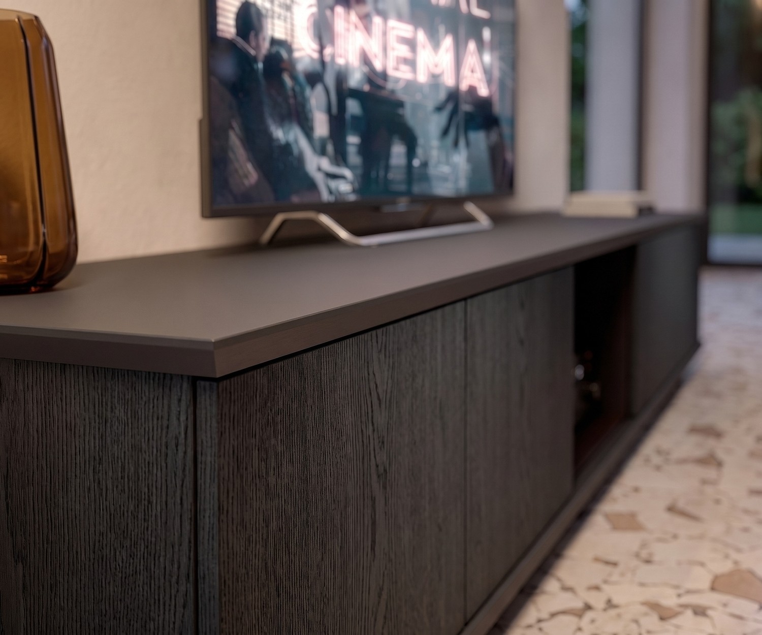 Ozzio Brera TV Media Lowboard in Dark Oak Ozzio Brera TV media lowboard in dark carbone oak with matte top in a modern living room setting.