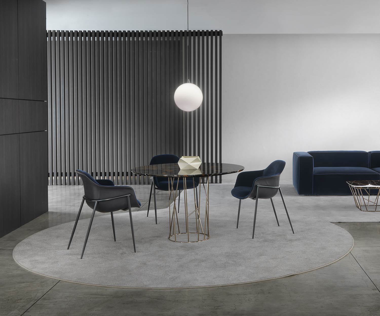 Elegant Twig marble dining table with three armchairs in the dining area of the living room