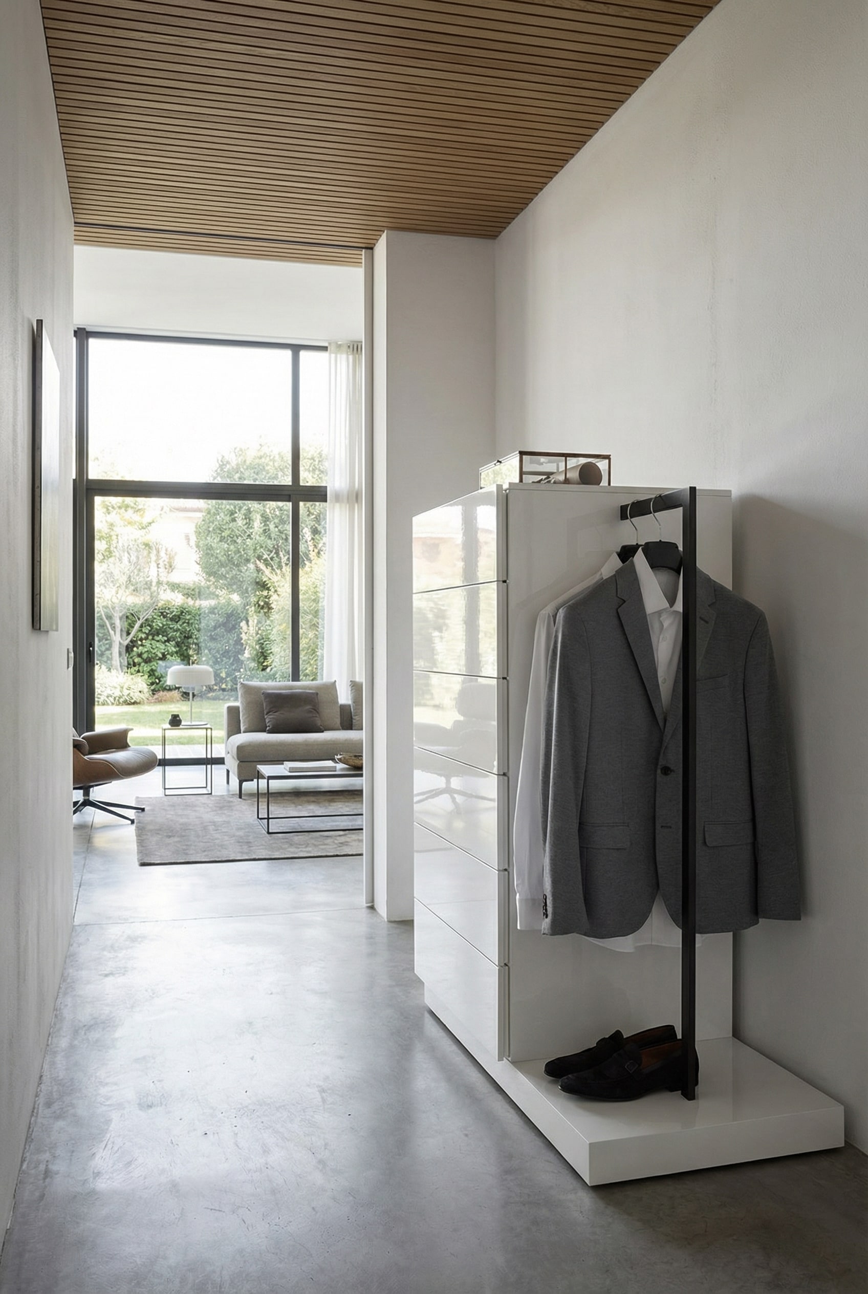 Multifunctional tall chest of drawers with integrated wardrobe in a stylish entryway. Multifunctional tall chest of drawers with integrated wardrobe in a stylish entryway.