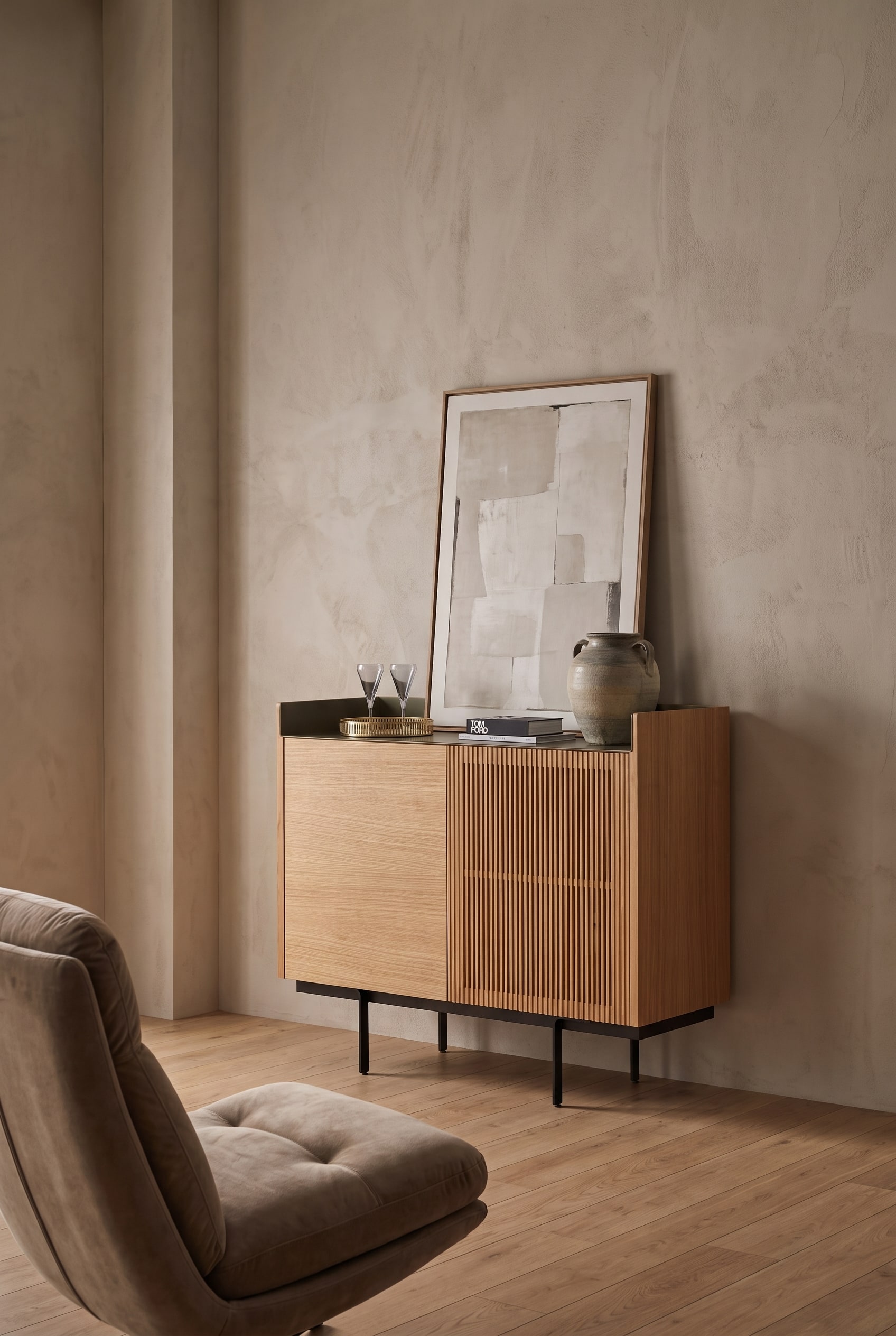 Spacious room with high ceilings, an elegant wooden highboard with a slatted front, and stylish art on top