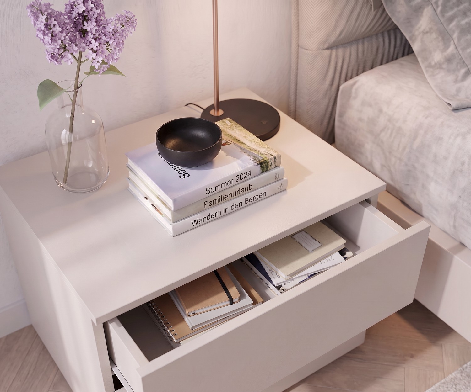 Livitalia Atena bedside table in a modern bedroom in light beige with an open drawer showing notebooks.
