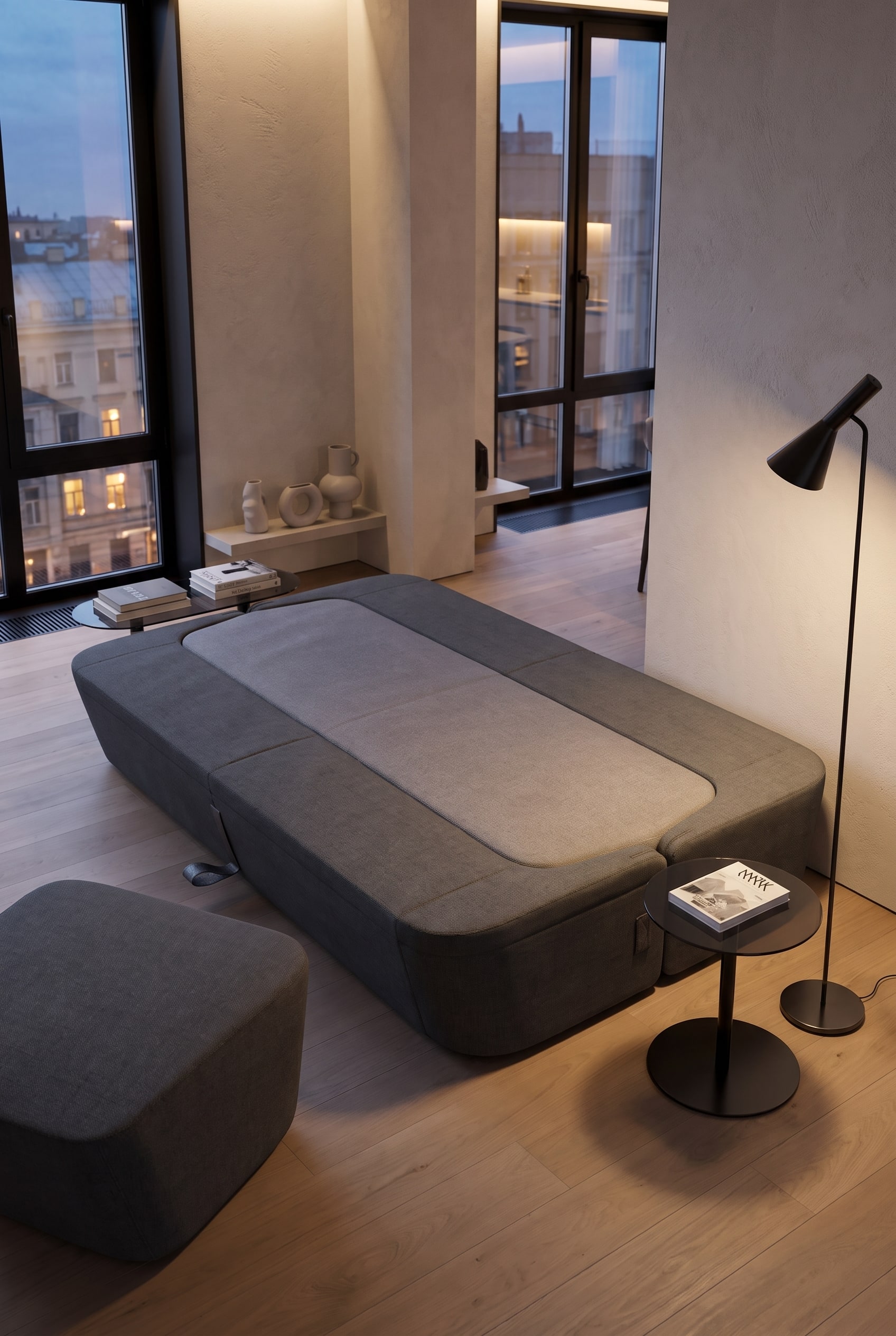 Soggiorno minimalista con divano letto di design grigio e lampada da terra elegante