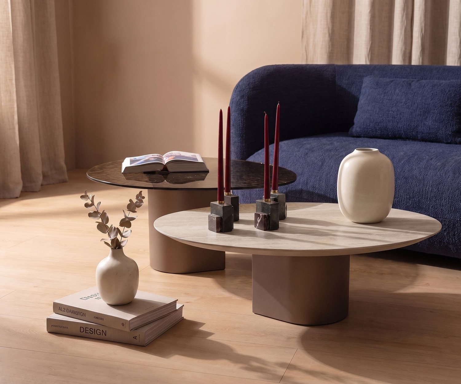 al2 dakry 006 coffee table set in a living room, organic teardrop base side tables with ceramic top next to a blue sofa