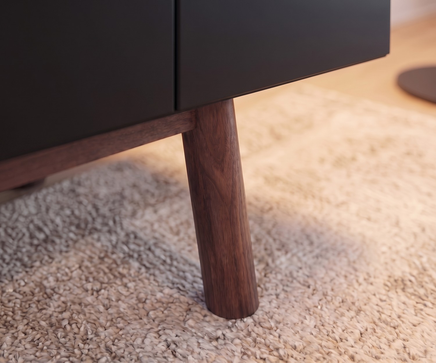 al2 designer sideboard MOS-I-KO 003 B with wooden legs al2 Designer sideboard MOS-I-KO 003 B, detail of solid wood leg and dark matte cabinet on a light textured living room rug.