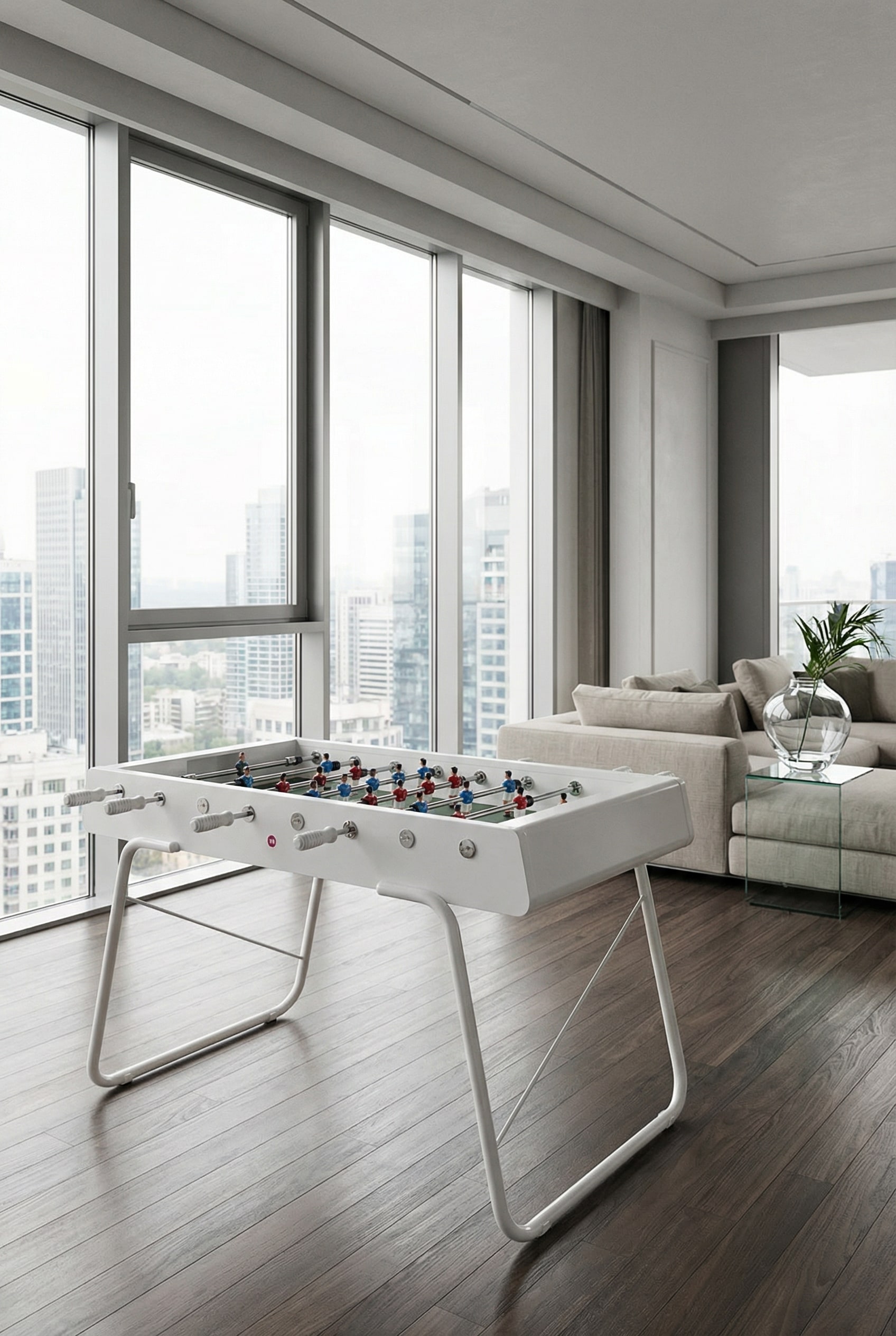 Modern, monochromatically painted steel foosball table in a light-filled, color-coordinated designer loft.