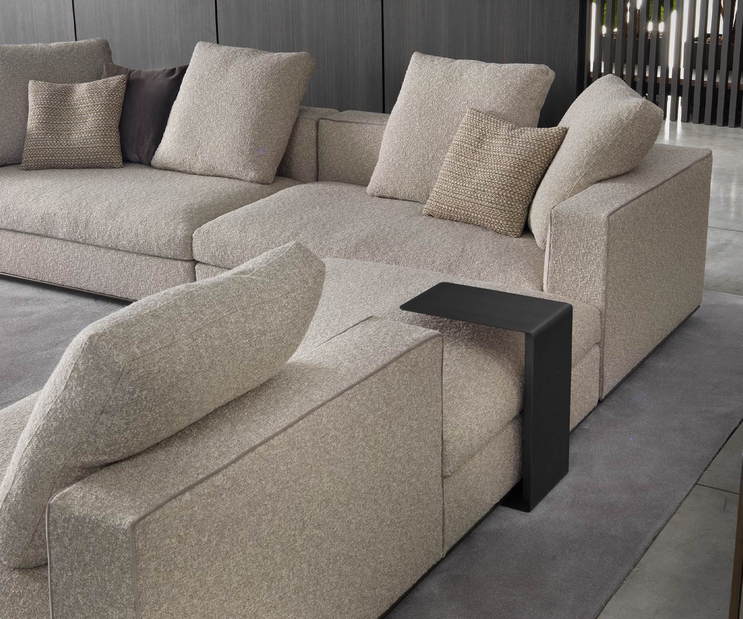 Black mini side table from Marelli inserted behind the couch Black mini side table from Marelli inserted behind the couch