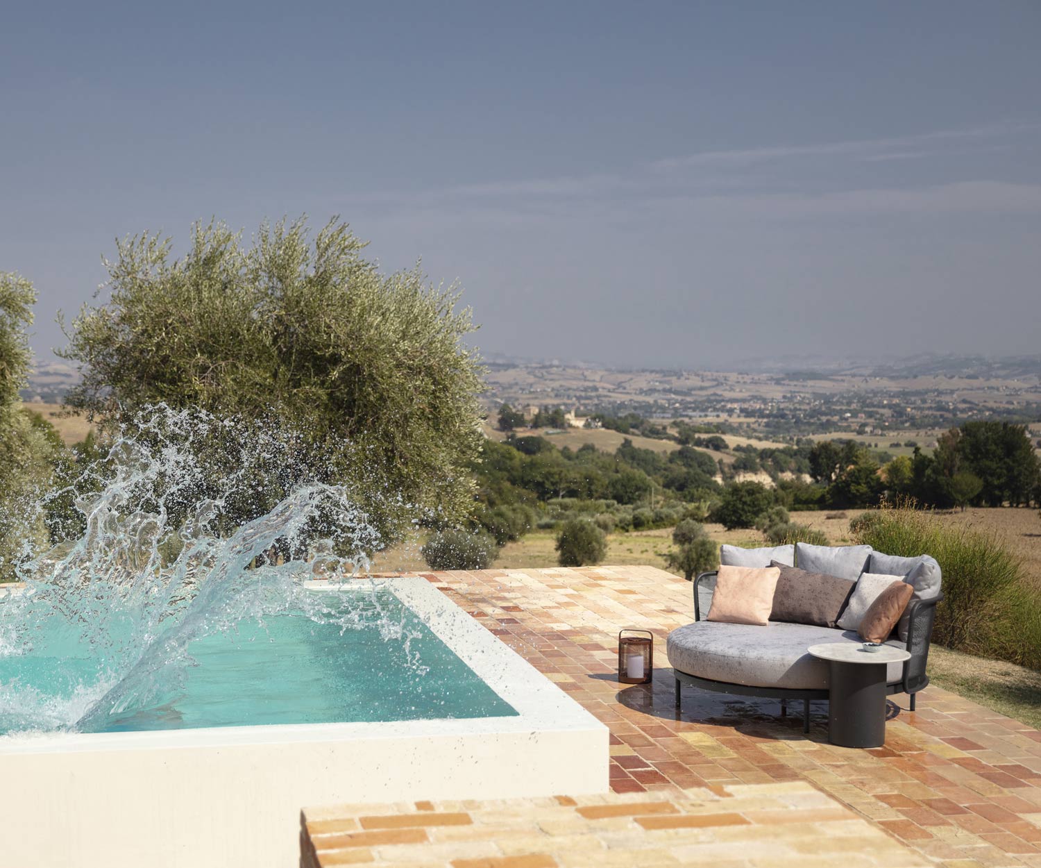 Baza Round Daybed drying in the sun after splashing around in the pool Baza Round Daybed drying in the sun after splashing around in the pool
