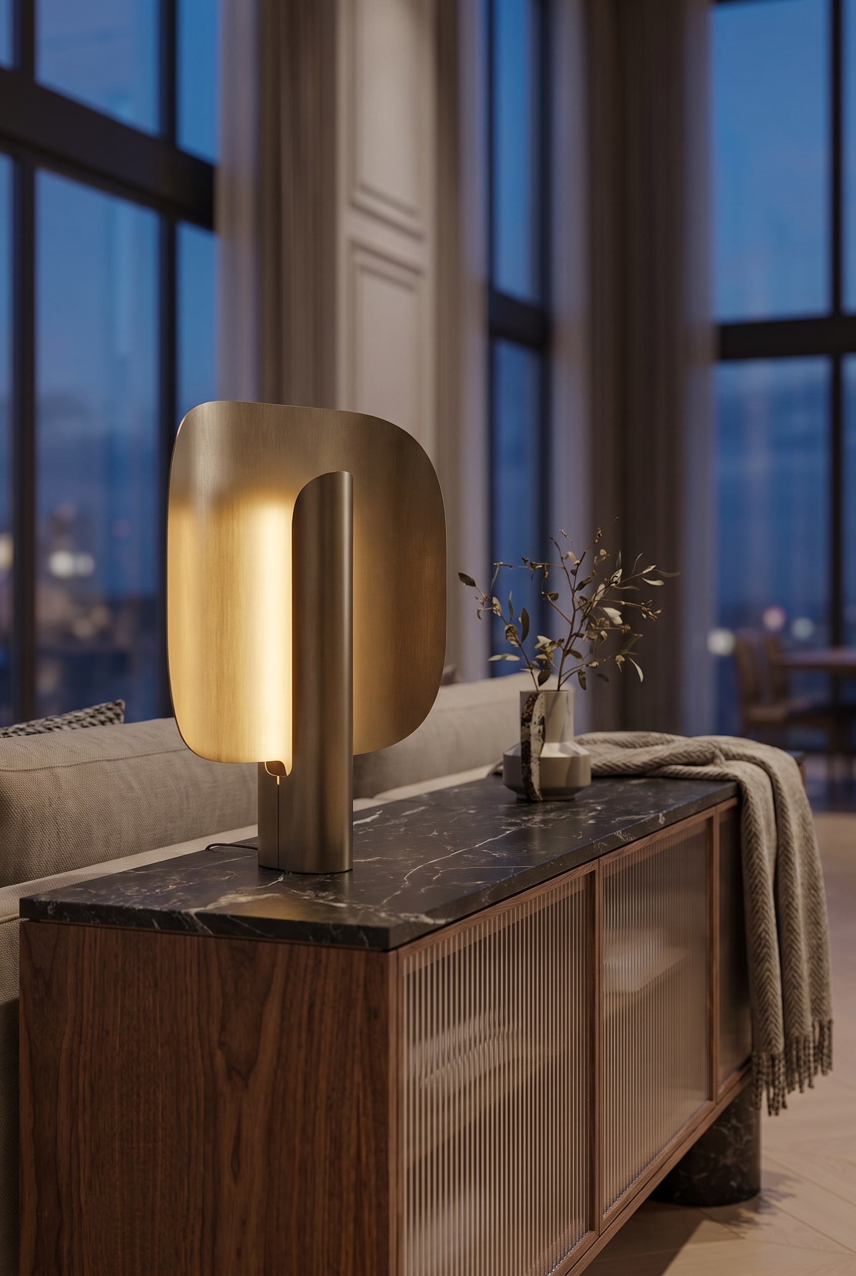 Luxurious living room with high ceilings, sculptural table lamp on an elegant wooden sideboard, and indirect room lighting