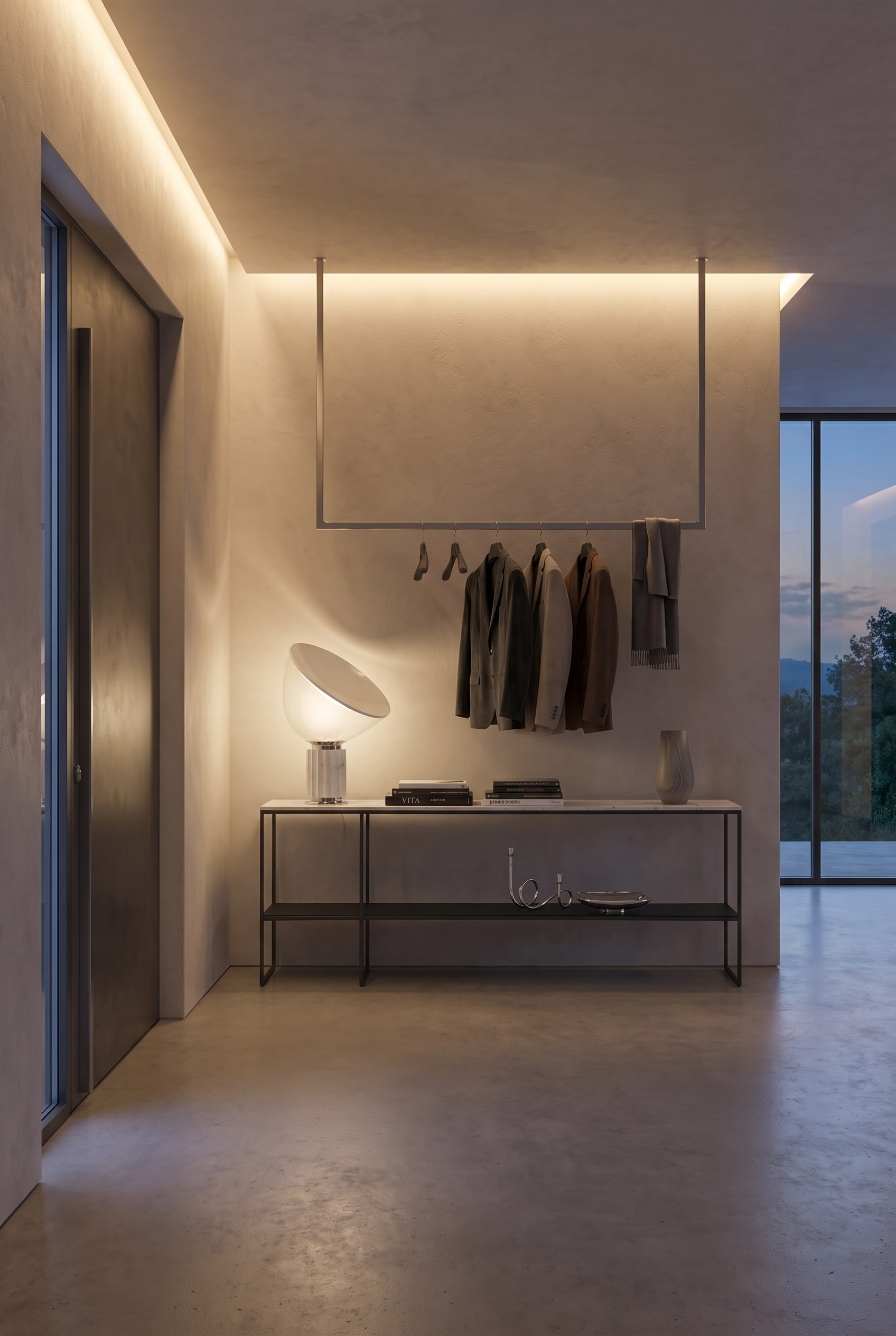 Moderne hal met open garderobe en een filigrane metalen console onder warm indirect licht