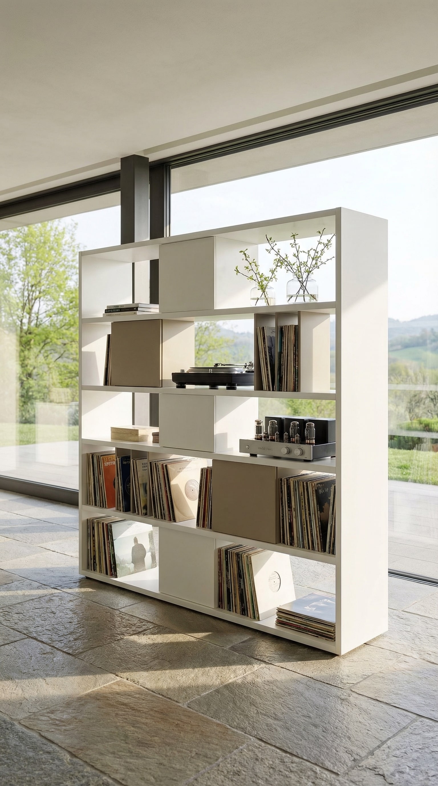 Freestanding shelf as a room divider with vinyl records and light filtering through