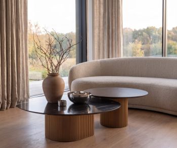 al2 dakry 006 coffee table set in a modern living room with a boucle sofa, featuring ribbed wooden bases.