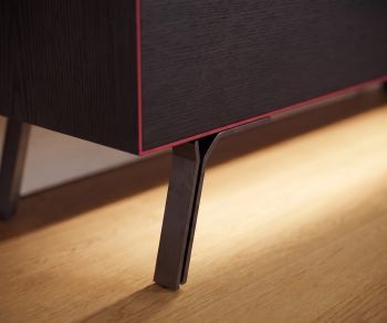 Livitalia Minimal lowboard in dark oak featuring slim anthracite metal legs, red edge detail and LED under-lighting.