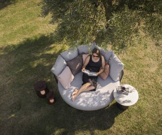 Contemplative Todus Baza Round Designer Daybed in the garden under a tree