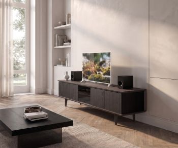 TV media lowboard Ozzio Brera in black oak with smoked glass front in a bright modern living room.