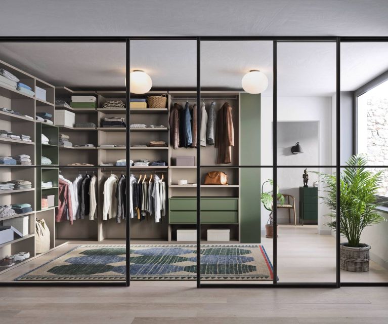 Walk-in design wardrobe Ben from Novamobili arranged in a corner