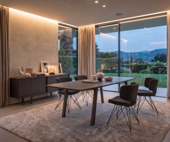 al2 mobius 001 dining table for family meals in a modern dining room with large panoramic windows and stylish chairs.