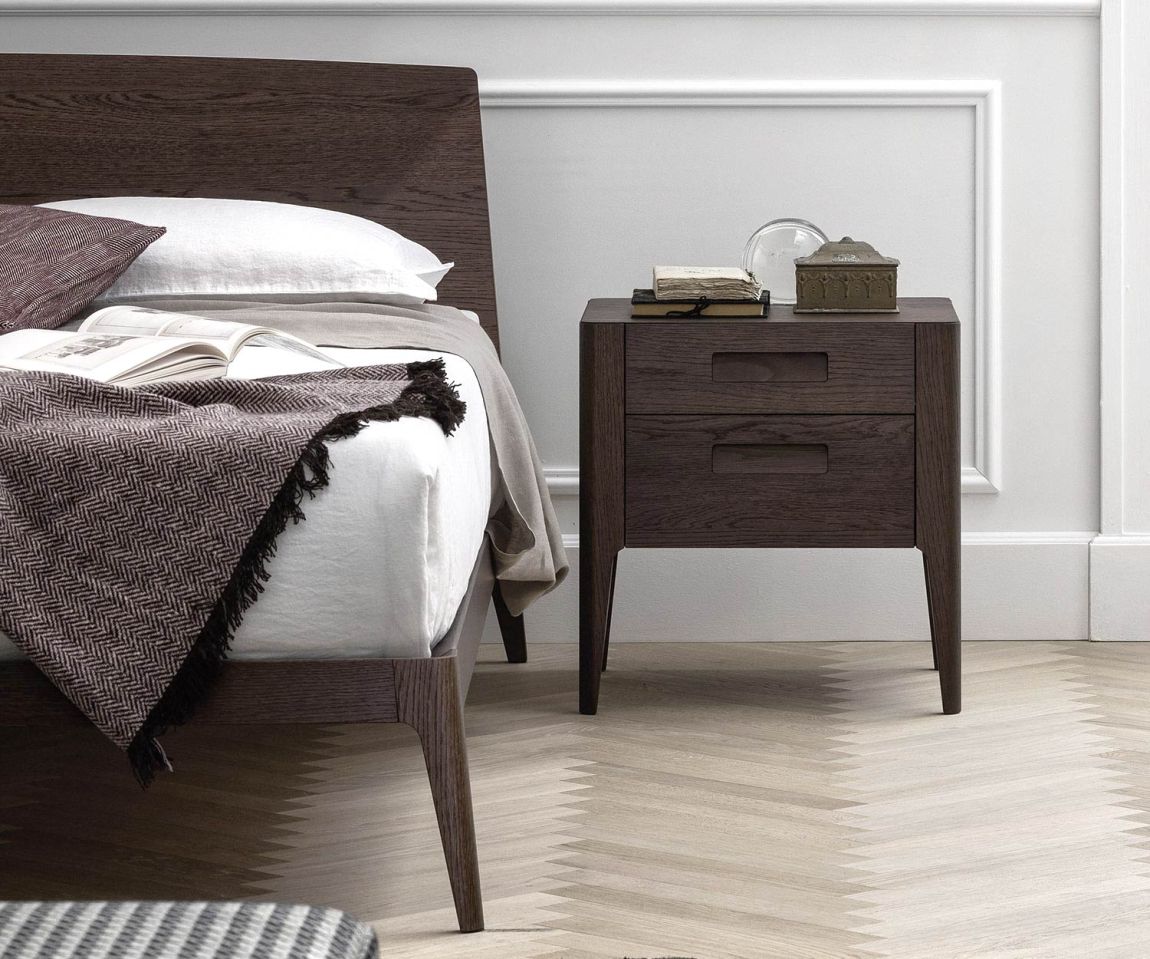 Modern dark designer wooden bed with bedside table in the bedroom
