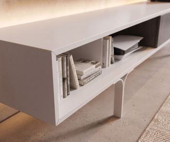 Mobius 005 TV lowboard in the living room for media storage. Minimalist white TV stand with open shelving and books.