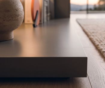 Livitalia Easy TV base platform for the living room. Modern dark grey low podium on wooden floor.