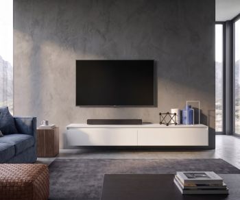 Wall-mounted TV lowboard Novamobili Reverse in a modern living room with concrete wall.